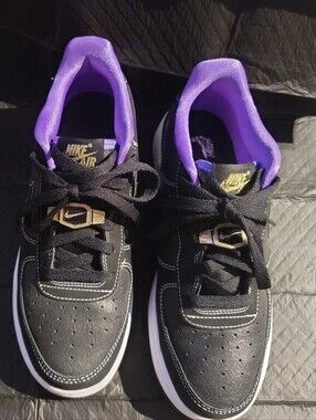 Nike Kids Black Sneakers with Purple Lining and Gold Logo